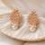 Rose gold crystal cluster earrings with pearl drop, marquise cut stones, stud style