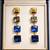Gold tone square crystal drop earrings, blue and grey stones, dangle style, 4-tier design