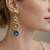 Gold tone drop earrings with multi-color crystal stones, dangle style, blue peach clear gems