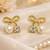 Bow stud earrings with pearl and crystal embellishments, elegant jewellery, anti tarnish jewellery