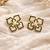 Flower stud earrings, gold-tone enamel with pearl centre, black and cream, push-back closure
