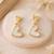 Gold-tone double heart drop earrings, white enamel pendant, stud back, dangle style