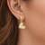 Gold-tone double heart drop earrings, white enamel pendant, stud back, dangle style