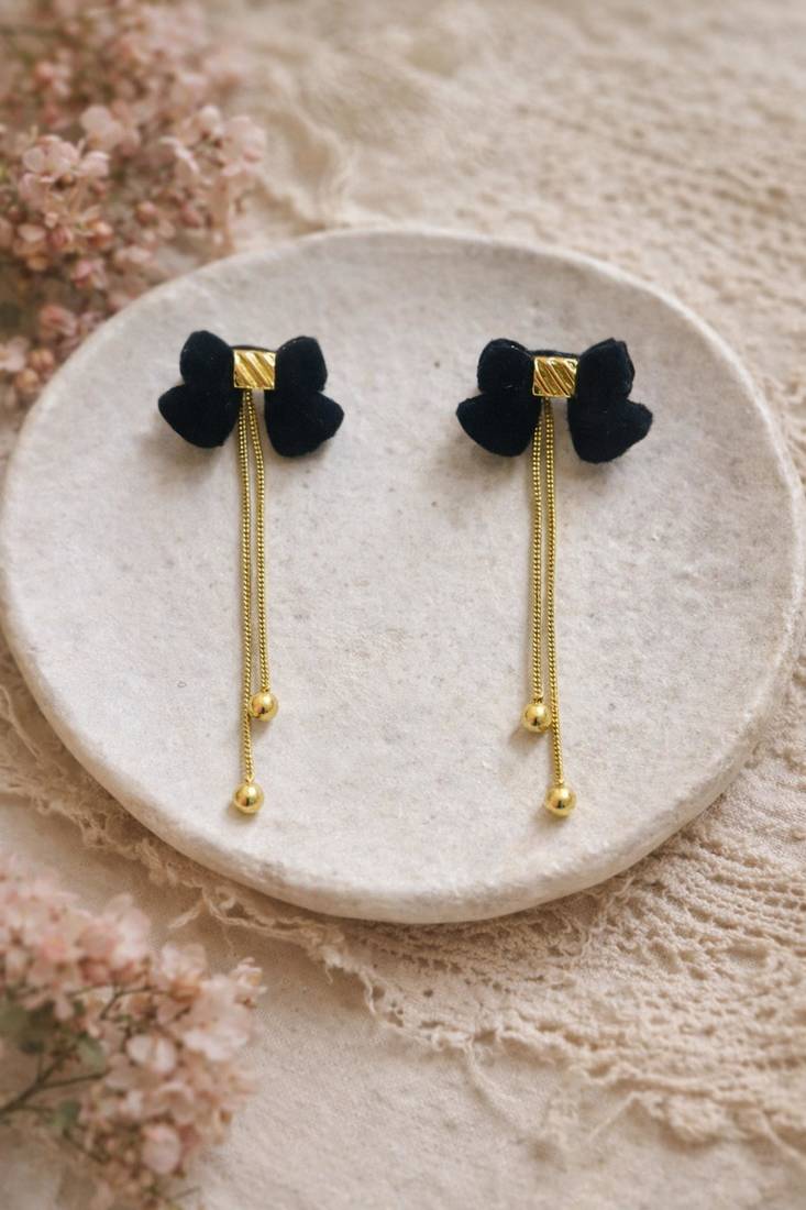 Black velvet bow stud earrings with gold chain tassel drop and ball ends, elegant dangle style