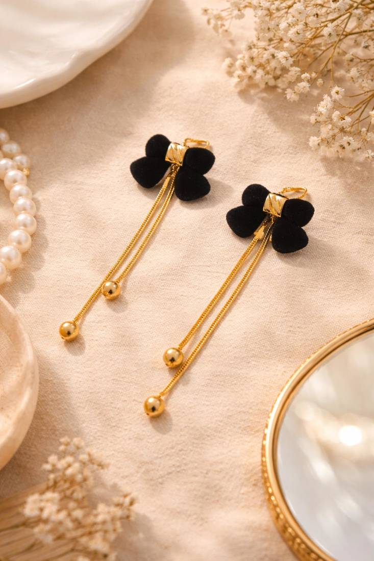 Black velvet bow stud earrings with gold chain tassel drop and ball ends, elegant dangle style