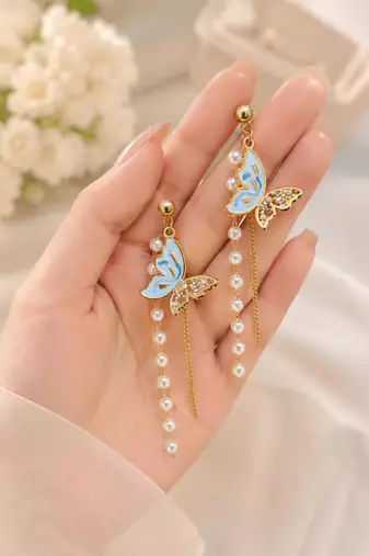 Blue enamel butterfly drop earrings with pearl chain tassel and crystal embellishments, gold-tone stud
