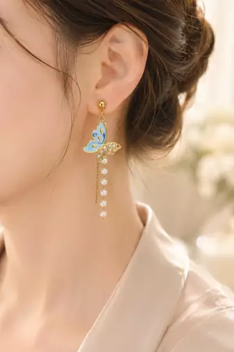 Blue enamel butterfly drop earrings with pearl chain tassel and crystal embellishments, gold-tone stud