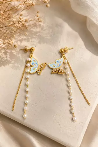 Blue enamel butterfly drop earrings with pearl chain tassel and crystal embellishments, gold-tone stud