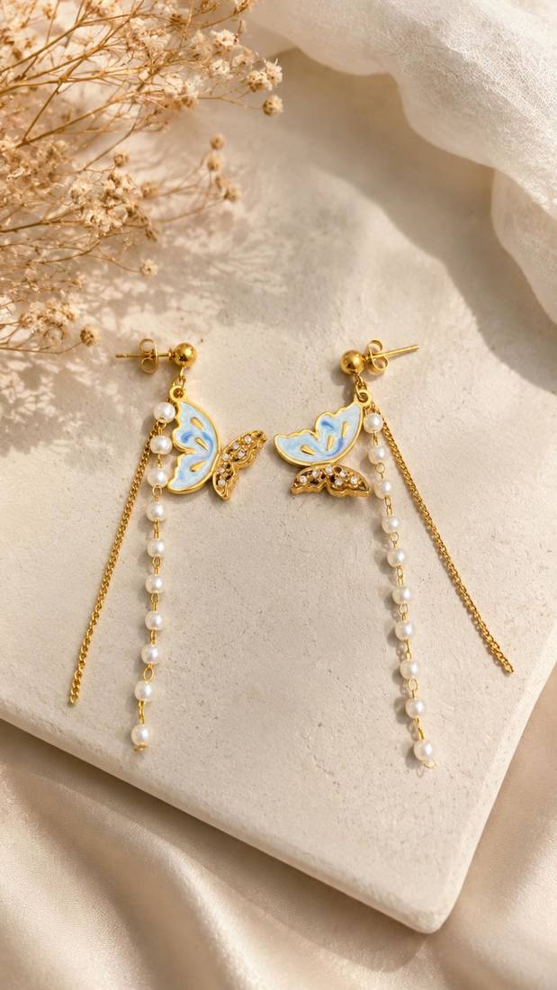 Blue enamel butterfly drop earrings with pearl chain tassel and crystal embellishments, gold-tone stud