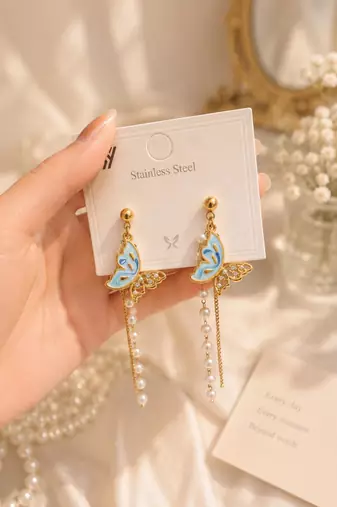Blue enamel butterfly drop earrings with pearl chain tassel and crystal embellishments, gold-tone stud