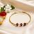 Divine rudraksha bead rakhi with gold-tone chain