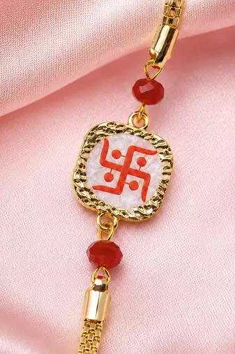 Traditional swastik charm rakhi with red beads