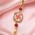 Traditional swastik charm rakhi with red beads