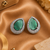 Rhodium finish serenity green halo earrings