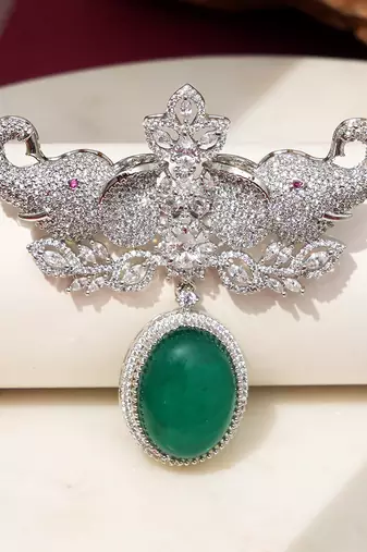 Rhodium plated green stone elephant head brooch