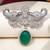 Rhodium plated green stone elephant head brooch