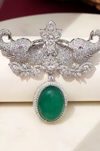 Rhodium plated green stone elephant head brooch