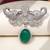 Rhodium plated green stone elephant head brooch