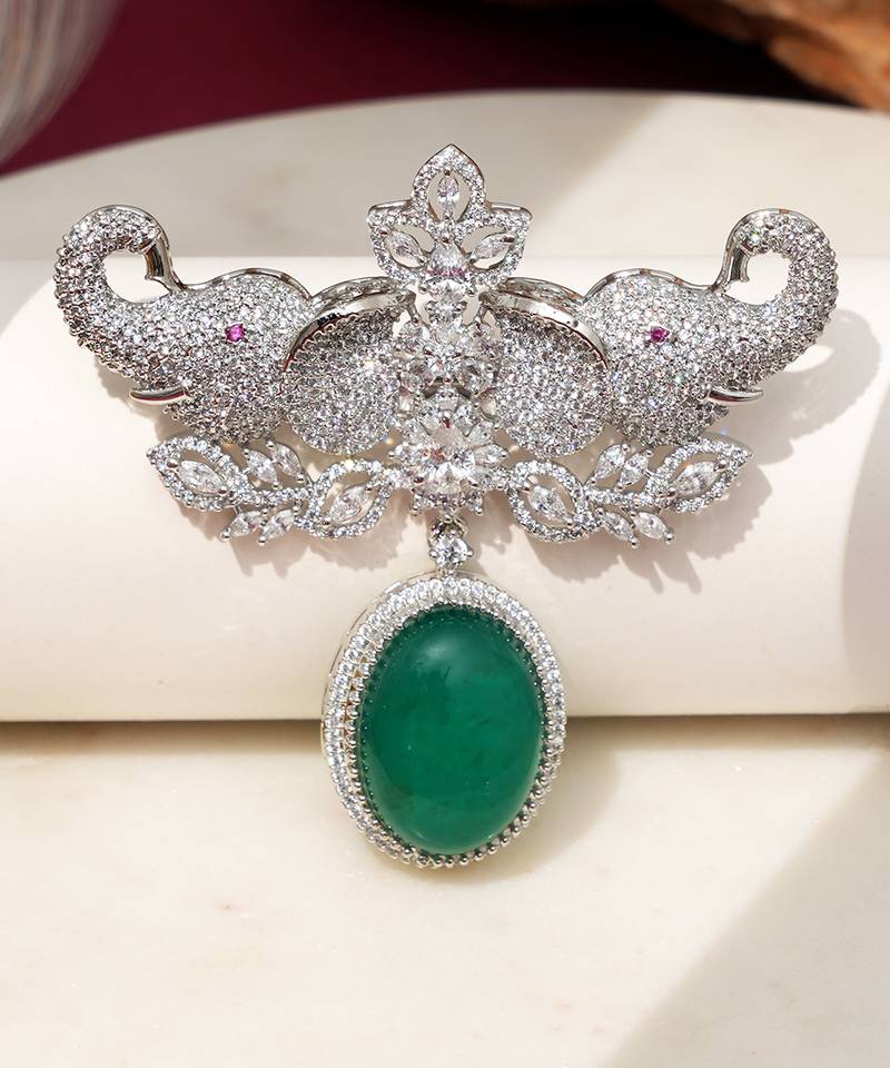Rhodium plated green stone elephant head brooch