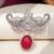 Rhodium plated ruby red stone elephant head brooch