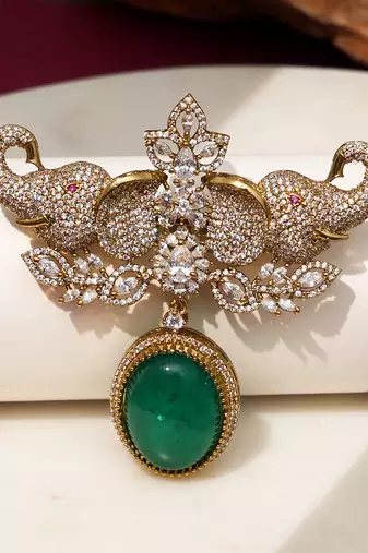 Gold plated emerald green stone elephant head brooch