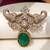 Gold plated emerald green stone elephant head brooch
