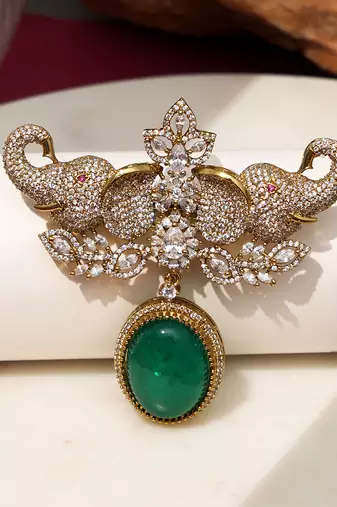 Gold plated emerald green stone elephant head brooch