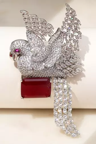 Rhodium plated ruby red stone bird motif brooch