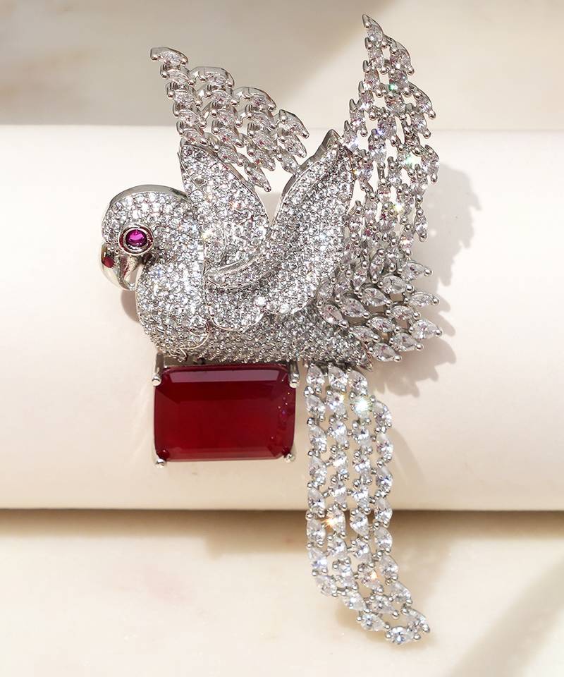 Rhodium plated ruby red stone bird motif brooch