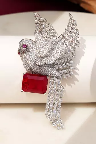 Rhodium plated ruby red stone bird motif brooch