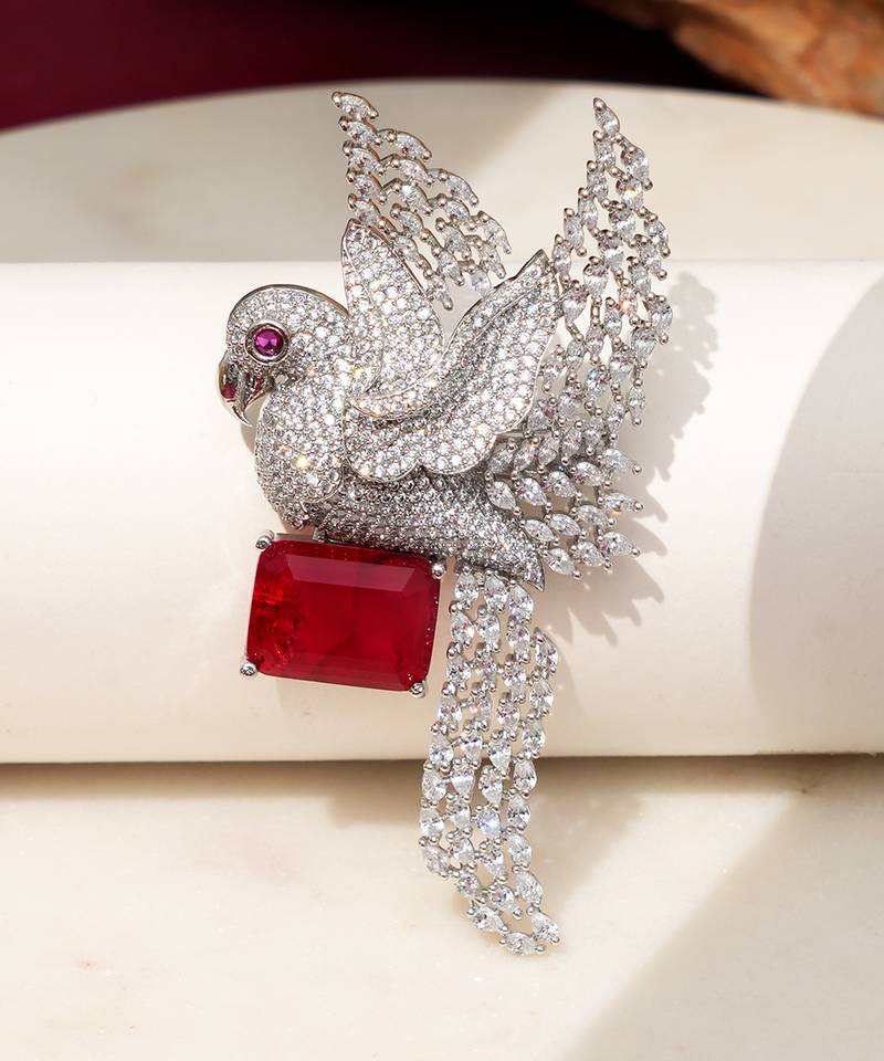 Rhodium plated ruby red stone bird motif brooch