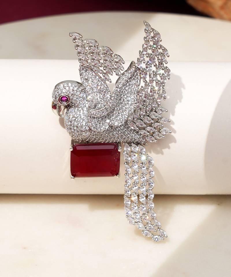 Rhodium plated ruby red stone bird motif brooch