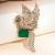 Gold plated green stone bird motif brooch