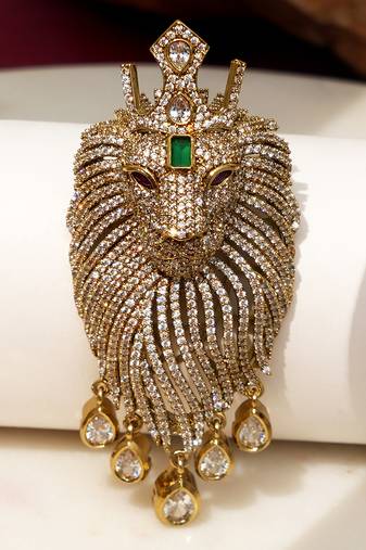 Gold plated green stone lion head brooch