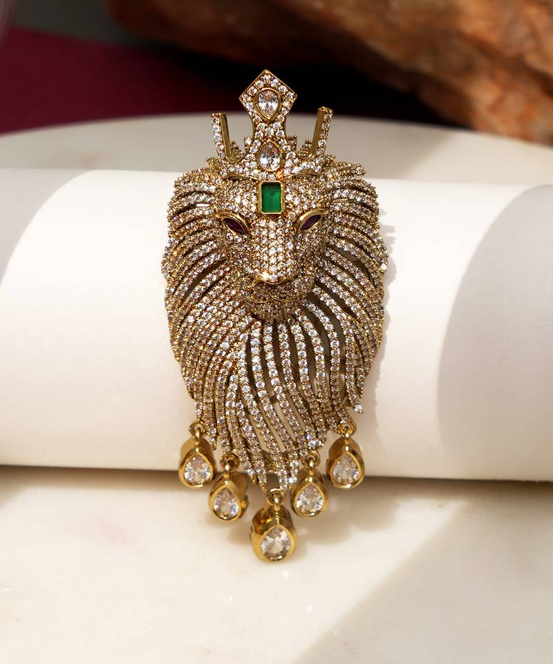 Gold plated green stone lion head brooch