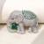 Silver plated green stone royal elephant brooch