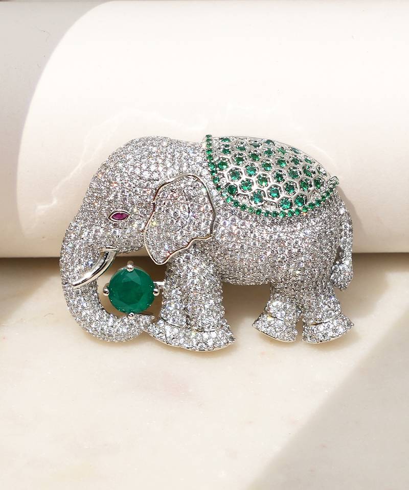 Silver plated green stone royal elephant brooch