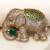 Gold plated emerald green stone royal elephant brooch