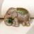 Gold plated emerald green stone royal elephant brooch