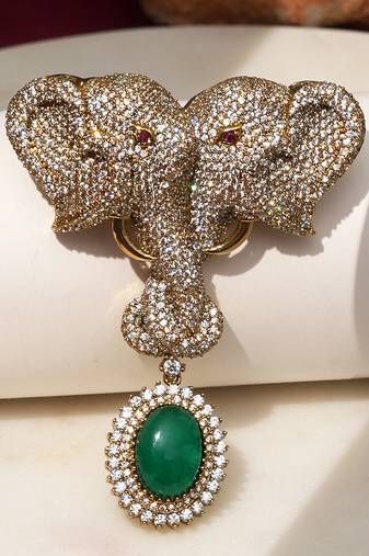Gold plated green stone twin elephant brooch