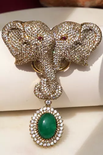 Gold plated green stone twin elephant brooch