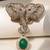 Gold plated green stone twin elephant brooch
