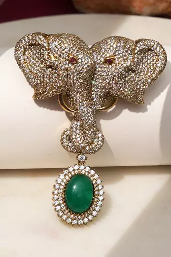 Gold plated green stone twin elephant brooch