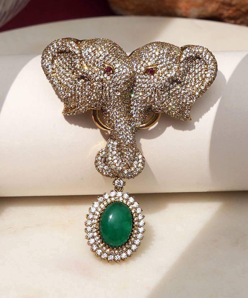 Gold plated green stone twin elephant brooch