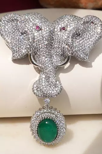 Silver plated green stone twin elephant brooch