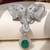 Silver plated green stone twin elephant brooch