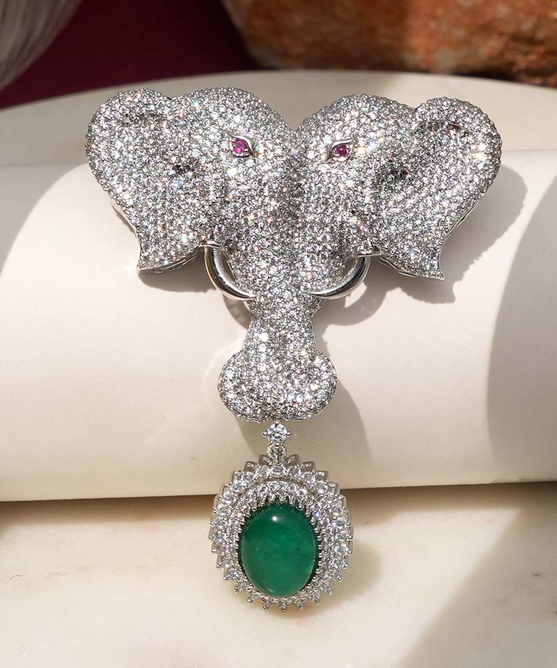Silver plated green stone twin elephant brooch