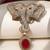 Gold plated ruby red stone twin elephant brooch