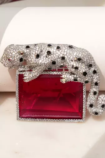 Silver plated ruby red stone crouching leopard brooch