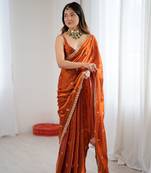Orange festive trendy satin saree with two tone sequence embroidery